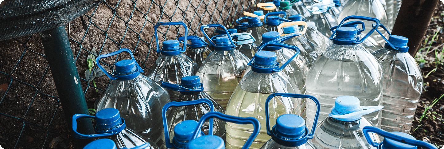 number plastic bottles full water front wall garden